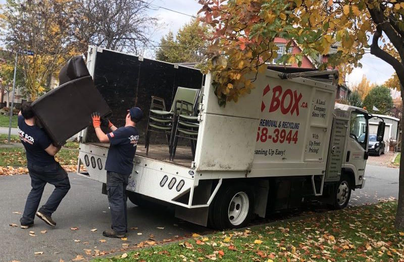 hauling old furniture into truck